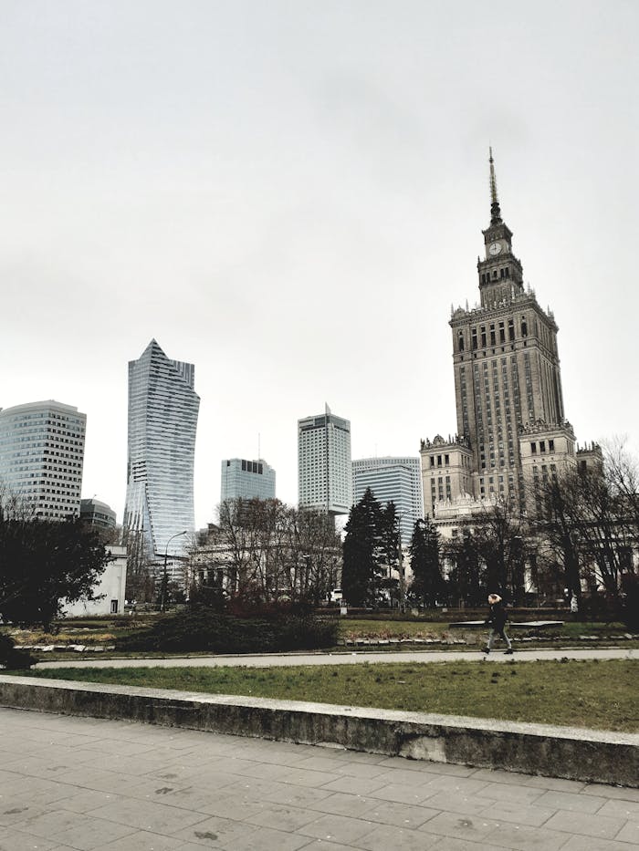 View of Warsaw's urban skyline featuring the Palace of Culture and Science on a cloudy day.